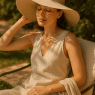 Fashion-savvy woman wearing best hats for sun protection in stylish sunlit garden setting