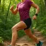 Confident woman running on forest trail wearing best trail running shoes for women in dynamic action