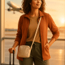 best travel clothes for women confident woman traveler at airport with stylish versatile outfit
