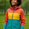 confident woman wearing best rain jackets for women standing outdoors in gentle rain nature background