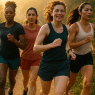 diverse women running wearing best running shorts for women on scenic morning trail