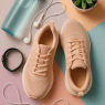 stylish flat lay of best walking shoes for women with walking accessories and fitness elements